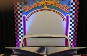 rock and roll photo backdrop with vintage car prop in front