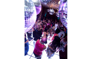 mirror balls suspended over a light up dance floor