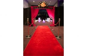 red carpet runner and red draped studio 54 entrance archway with lights