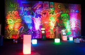 graffiti themed backdrop with old fashioned arcade games and light up furniture