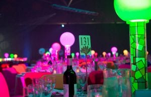 Room shot at Perth Convention Centre pavilion for gala dinner showing 1980s themed table centrepieces