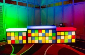 three pieces of illuminated bar with coloured top and a rubix cube design printed on the front of the bar