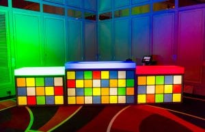 three pieces of illuminated bar with coloured top and a rubix cube design printed on the front of the bar