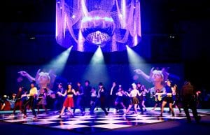 large black and white dance floor with custom ceiling chandelier of beaded curtains and giant 2m mirror ball. Dance performance on dance floor