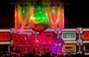 large black and white dance floor with custom ceiling chandelier of beaded curtains and giant 2m mirror ball. Dance performance on dance floor