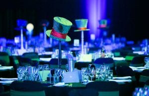 alice in wonderland themed table centrepieces. mad hatter hats on stands