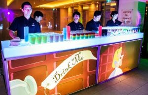 illuminated bar with customised sticker on front saying drink me and with images of alice in wonderland theme