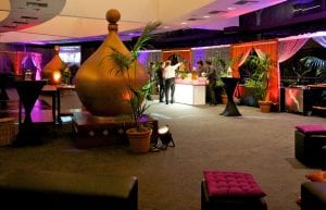 large gold dome prop and arabian archway drapes with illuminated bar and palm trees