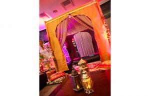 arabian nights theming chill out tent with silk drapes low wooden table persian rug and lanterns