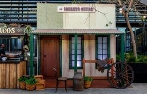 Wild West modern event styling theme with food hut furniture, native florals, chair, horse saddle, sheriffs office prop for hire. Photo taken at Camfield Perth for Christmas Party.