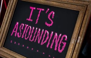 Rocky Horror event theme with gold frames and custom signage for hire.