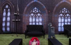 Rocky Horror event theme with coffin coffee table, gothic window drape backdrop, hi back sofas, rectangular ottomans, candelabra, parcan lights, skeletons and cemetery props for hire.