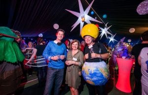Space event theme with black drapes, led dance floor, star cloth, giant inflatable stars, illuminated led bar furniture, and wicker ball lights for hire