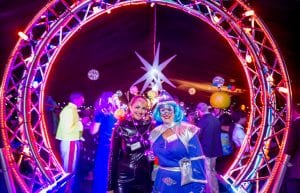 Space event theme with black drapes, led dance floor, star cloth, giant inflatable stars, curved trussing entry feature, illuminated led hi bar furniture, lycra hi bar covers, coloured ghost stools, tiered orb centrepieces and wicker ball lights for hire.
