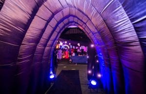 Space event theme with black drapes, led dance floor, star cloth, giant inflatable stars, curved trussing entry feature, illuminated led hi bar furniture, lycra hi bar covers, coloured ghost stools, tiered orb centrepieces, inflatable tunnel entry feature and wicker ball lights for hire.