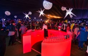 Space event theme with black drapes, led dance floor, star cloth, giant inflatable stars, illuminated led bar furniture, and wicker ball lights for hire
