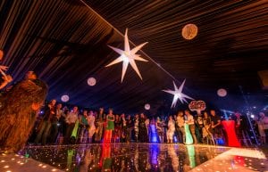 Space event theme with black drapes, led dance floor, star cloth, giant inflatable stars, illuminated led bar furniture, and wicker ball lights for hire