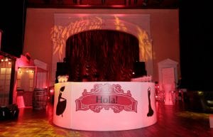 Spanish event theme with, drapes, bunting, illuminated led cocktail furniture, illuminated led bar, coloured ghost stools, wine barrels, food huts and Spanish styling props for hire.
