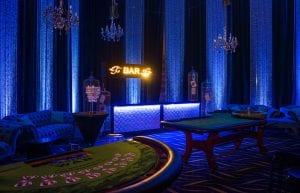 Las Vegas event styling theme with, pressed tin light up bar, velvet sofas, birdcages, playing cards, centrepieces, chandeliers, cushions, hi bar tales, stools, casino tables, beaded curtains for hire. Photo taken at Crown Perth for Christmas Party.