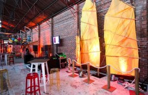 Vietnam Asian event styling theme with, lanterns, Arabian rugs, coffee tables, throne, sofa, cushions, pressed tin bar, food hut stations, stools and lantern backdrop for hire.
