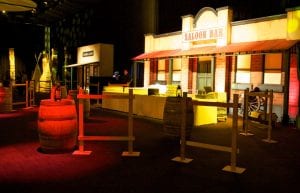 Wild West event styling theme with savings and loan building prop, cactus props, saloon doors, wine barrels and light up led bar for hire.