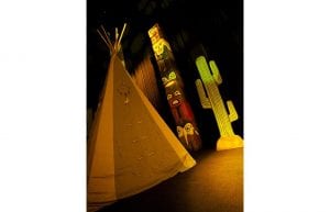 Wild West event styling theme with tee pee tents, fake fire, totem pole props and wild west backdrop for hire