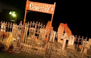 Wild West event styling theme with entry feature, horse saddles, hay barrels, cemetery, rocks for hire.