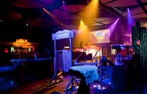 Wild West event styling theme with savings and loan building prop, cactus props, saloon doors, wine barrels and light up led bar for hire.