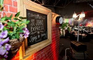 harry potter event theme with brick wall prop, clock prop, lamp post, chalkboard sign and frame prop for hire.